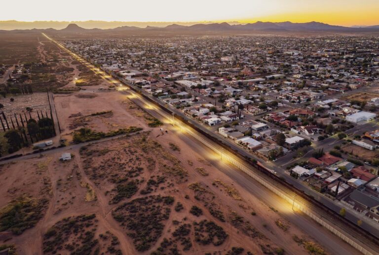 An aerial view shows the south side of the city of Douglas next to the double wall on the US-Mexico next to the Mexican city of Agua Prieta (L) in Douglas, Arizona, on October 15, 2024. (OLIVIER TOURON/AFP via Getty Images)