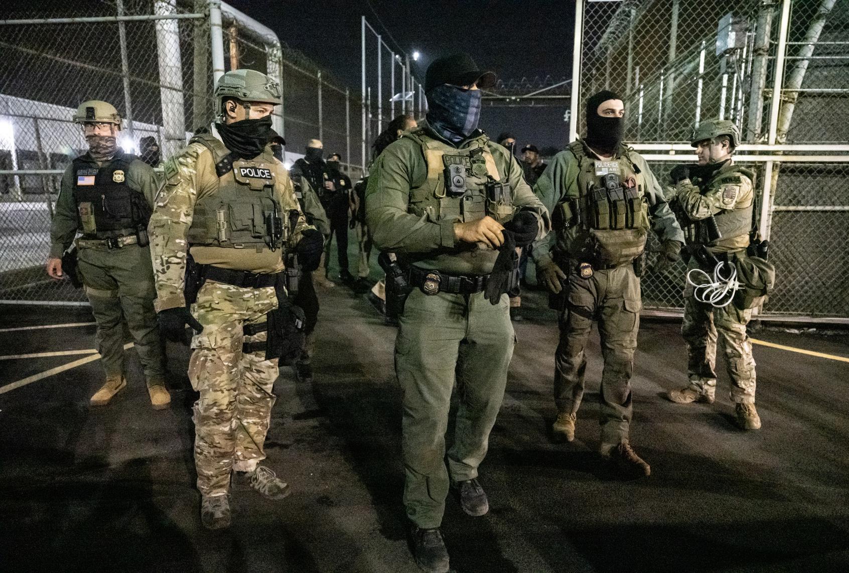 NEWARK, NEW JERSEY - JUNE 12: U.S. Immigration and Customs Enforcement (ICE) agents guard outside Delaney Hall, a migrant detention facility, while anti-ICE activists demonstrate on June 12, 2025 in Newark, New Jersey. Anti-ICE protests have been spreading to cities across America since Ice deportation quotas have increased. (Photo by (Stephanie Keith/Getty Images)