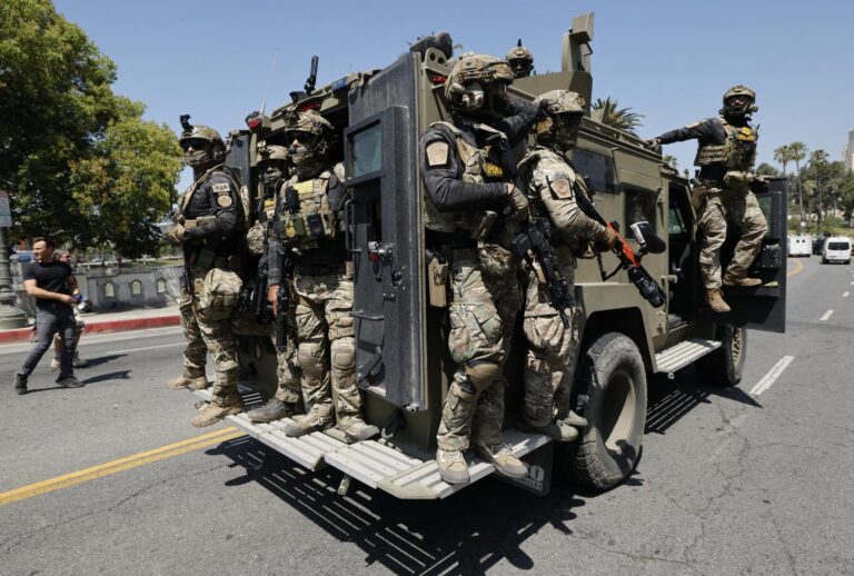 Federal immigration agents near MacArthur Park in the Westlake area on July 7, 2025. (Carlin Steihl/Los Angeles Times via Getty Images)