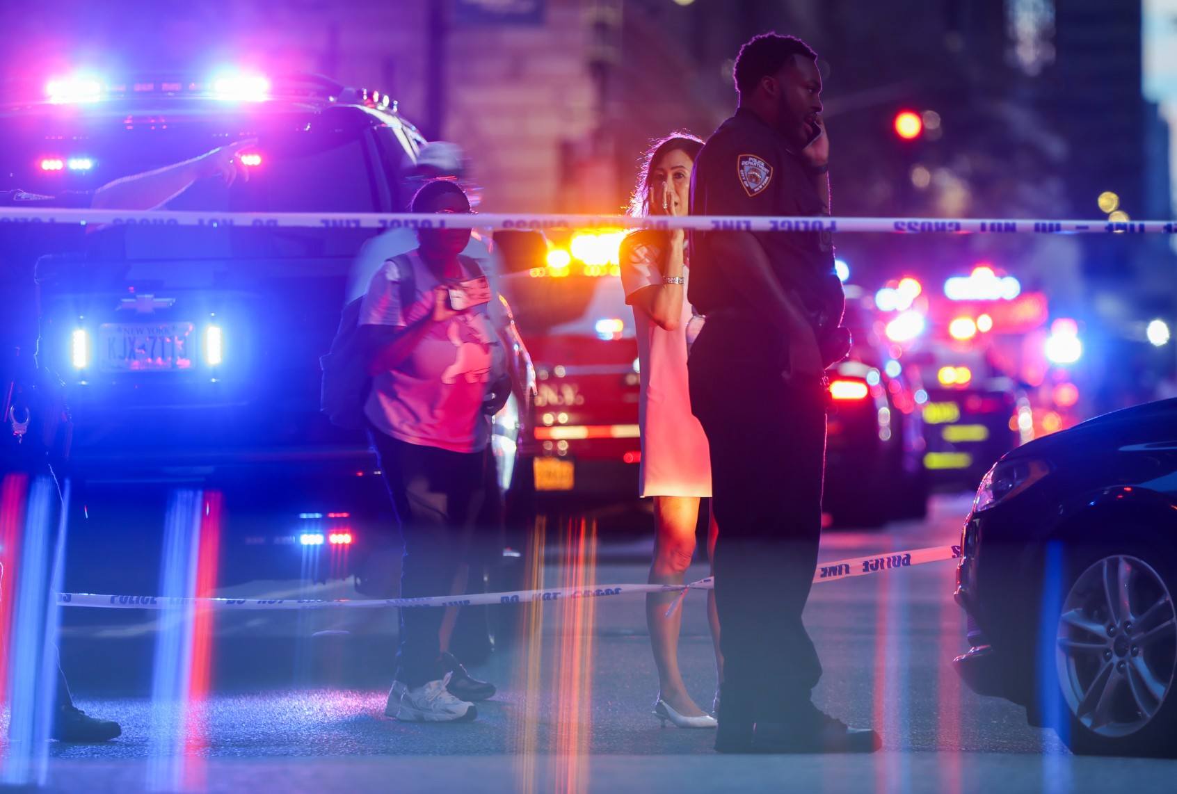 Police and others gather at a crime scene in midtown Manhattan after two people, including a police officer, were shot inside of an office building on July 28, 2025 in New York City. (Spencer Platt/Getty Images)