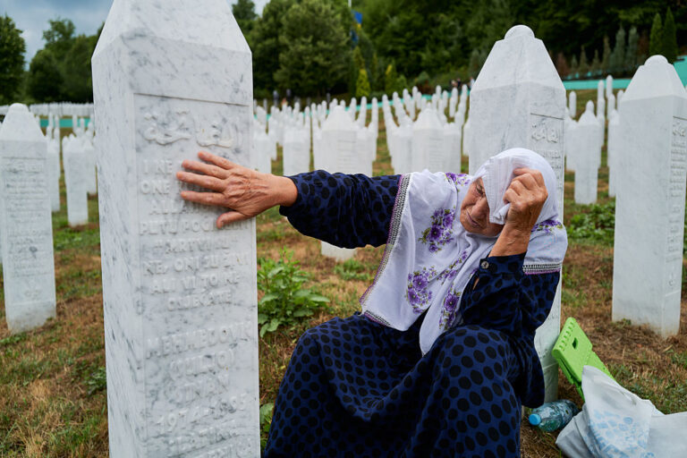 A woman mourns her two sons, who were executed by Bosnian Serb forces during the Srebrenica genocide, at the Potocari cemetery. (hoto by Pierre Crom/Getty Images)