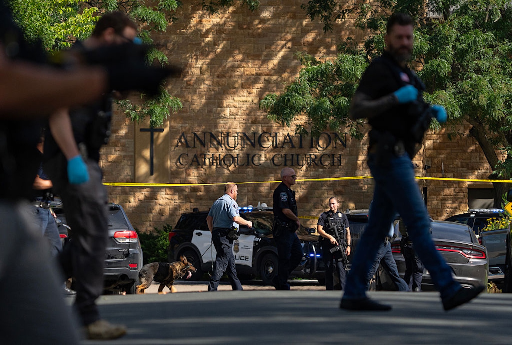 Law enforcement officers search the neighborhood after a shooting at Annunciation Catholic School in Minneapolis, Minn. on Aug. 27, 2025. (Alex Kormann/The Minnesota Star Tribune via Getty Images)