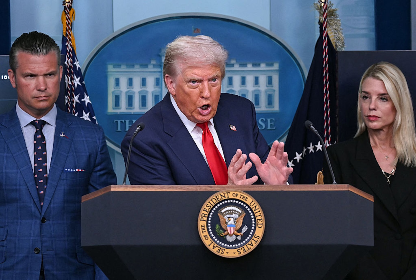 President Donald Trump, flanked by Secretary of Defense Pete Hegseth and Attorney General Pam Bondi, announces his takeover of Washington, D.C. on Aug. 11, 2025. (ANDREW CABALLERO-REYNOLDS/AFP via Getty Images)
