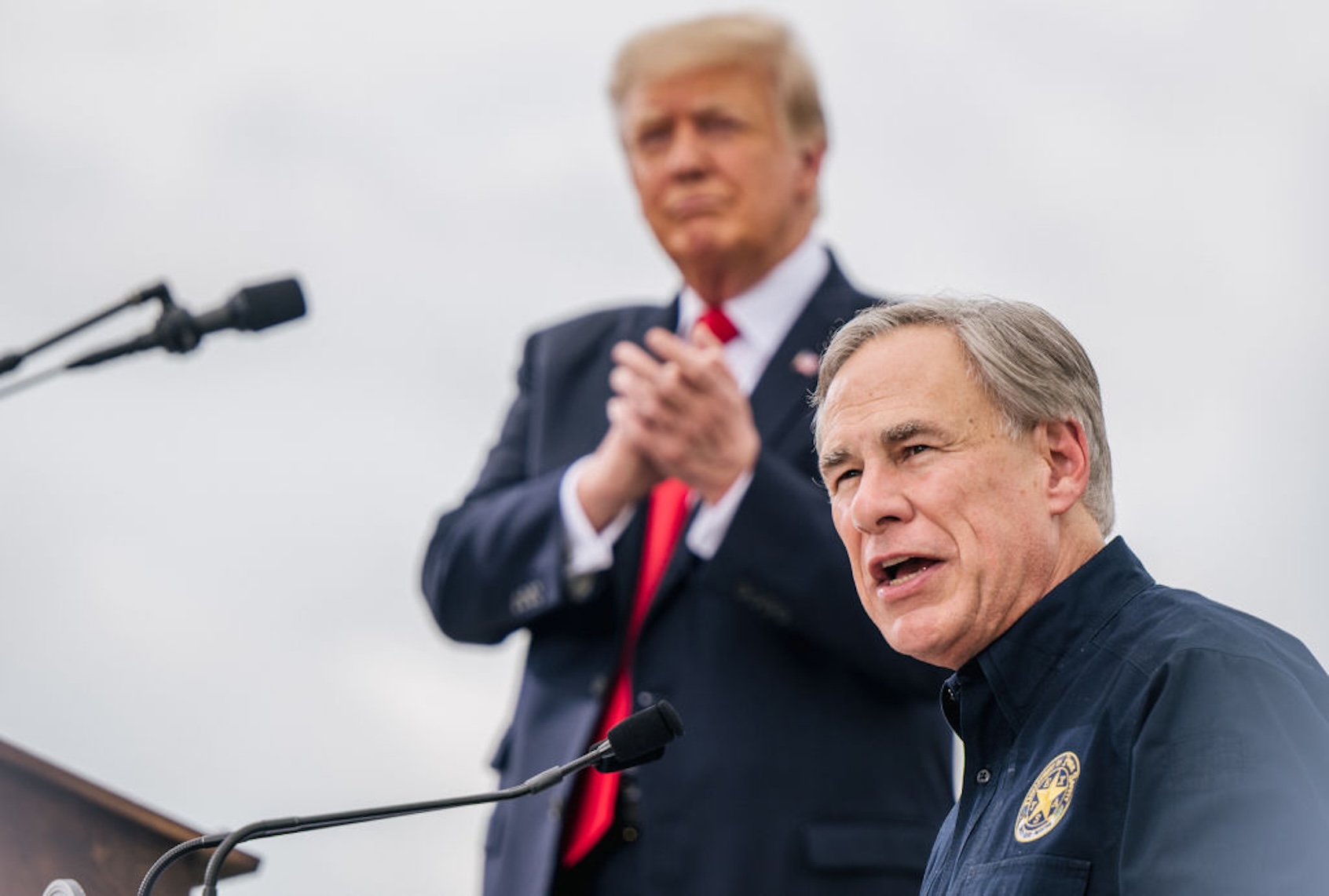Texas Gov. Greg Abbott and (then-former) President Donald Trump speak in Pharr, Texas, on June 30, 2021. (Brandon Bell/Getty Images)