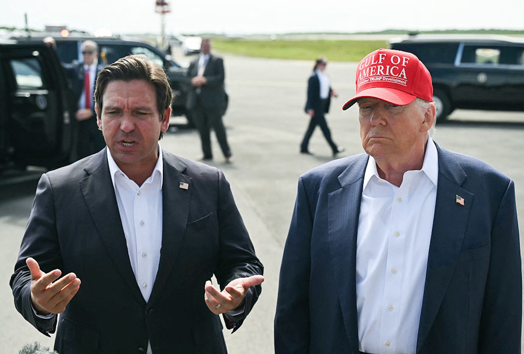 Florida Gov. Ron DeSantis and President Donald Trump speak to reporters before touring a migrant detention center dubbed "Alligator Alcatraz." (ANDREW CABALLERO-REYNOLDS/AFP via Getty Images)