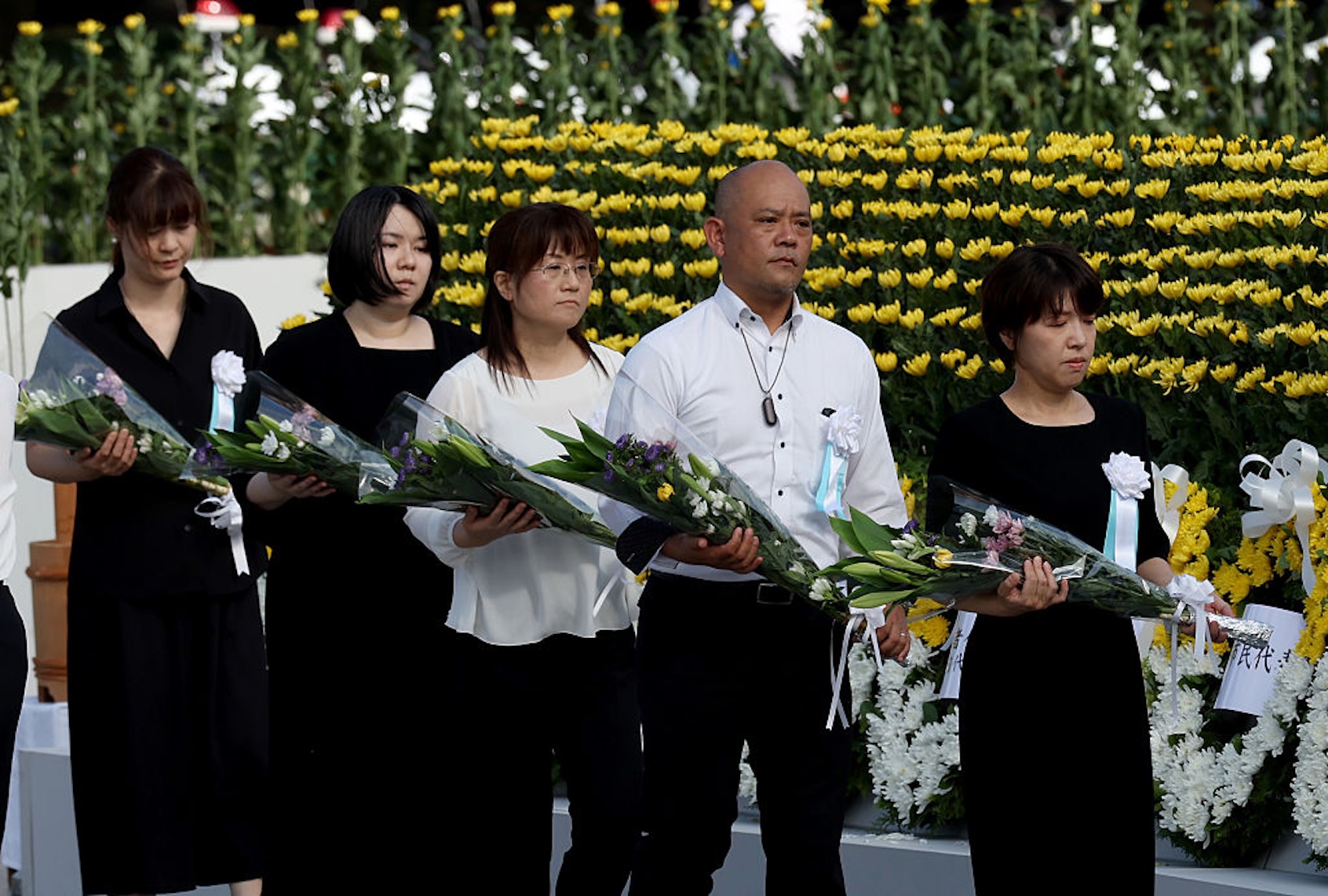 People lay flowers at the Hiroshima Peace Memorial after a ceremony commemorating the 80th anniversary ceremony of the atomic bombing on Aug. 6, 2025. (Buddhika Weerasinghe/Getty Images))