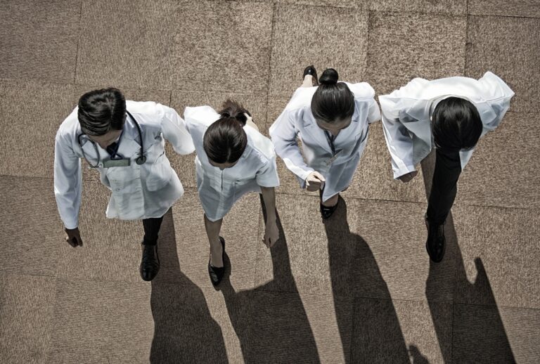 Doctors walking outside. (RUNSTUDIO/Getty Images)