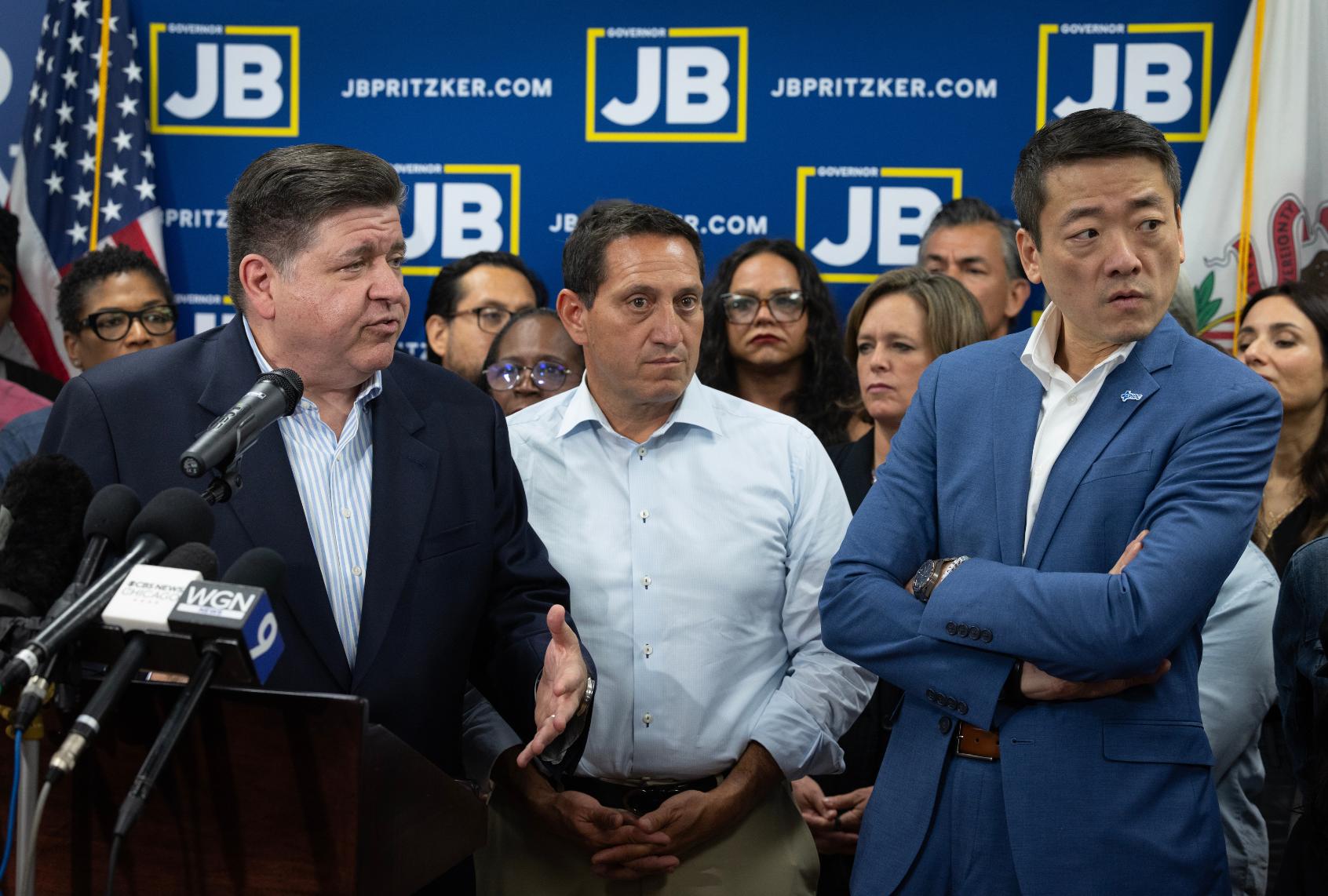 Texas Rep. Trey Martinez Fischer (C) and Texas House Democratic Caucus Chair Gene Wu (R) listen as Illinois Governor JB Pritzker speaks to reporters during a press conference at the DuPage County Democratic Party headquarters on August 03, 2025 in Carol Stream, Illinois. (Scott Olson/Getty Images)