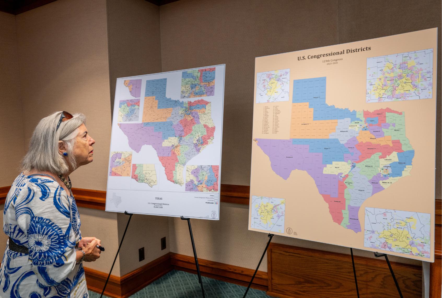 A person, who declined to be named, views a U.S. Congressional District map as the Senate Special Committee on Congressional Redistricting meets to hear invited testimony on Congressional plan C2308 at the Texas State Capitol on August 6, 2025 in Austin, Texas. (Brandon Bell/Getty Images)