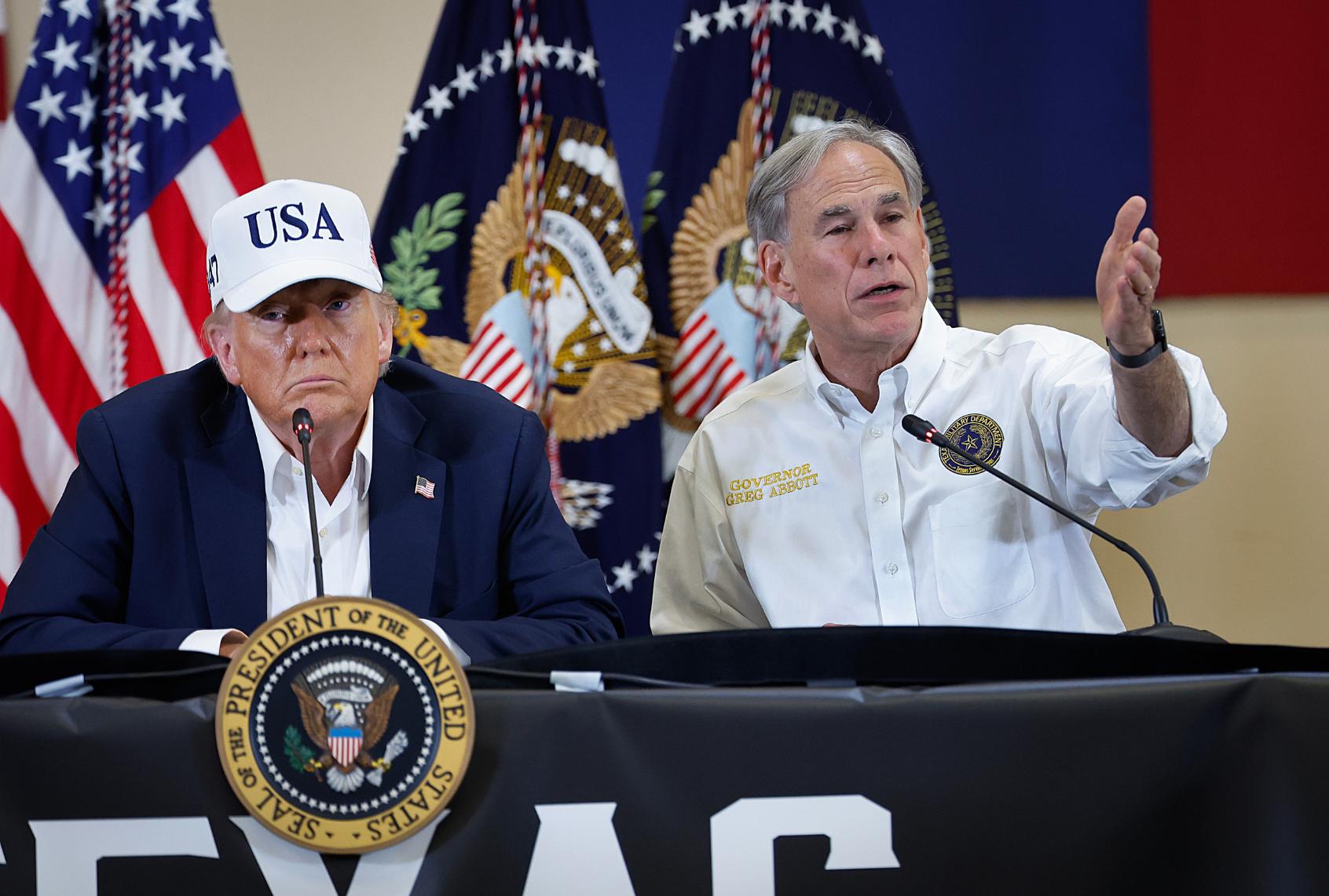 President Donald Trump and Texas Governor Greg Abbott participate in a round table event at the Hill Country Youth Event Center to discuss last week's flash flooding on July 11, 2025 in Kerrville, Texas. (Chip Somodevilla/Getty Images)
