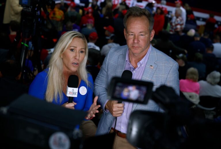 Brian Glenn interviews Rep. Marjorie Taylor Greene, R-Ga., on camera during a campaign rally for Donald Trump on March 9, 2024. (Chip Somodevilla/Getty Images)