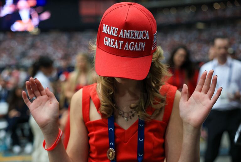 An attendee prays at the memorial service for political activist Charlie Kirk at State Farm Stadium on Sept. 21, 2025 in Glendale, Ariz. (Joe Raedle/Getty Images)