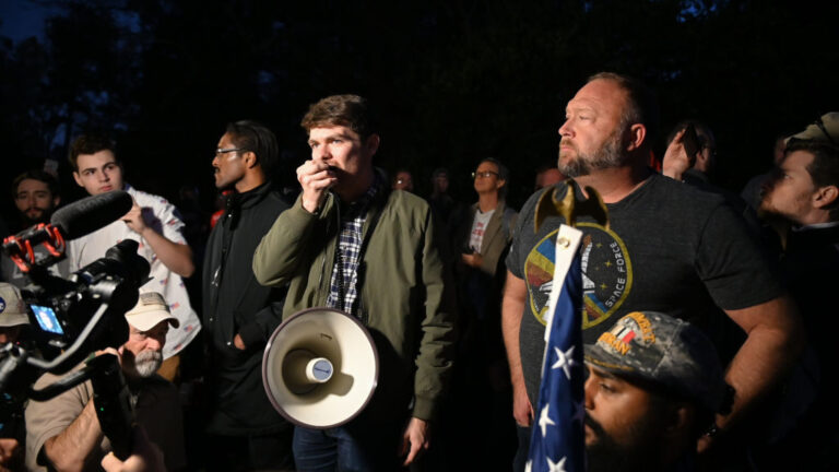 Extreme far-right activists and their nickname "groyper" are trending online thanks to an alleged connection with Charlie Kirk's shooting. Here, Fuentes (C) hold a rally with fellow extreme conservative Alex Jones (R) in 2020. (Zach Roberts / NurPhoto / Getty Images)