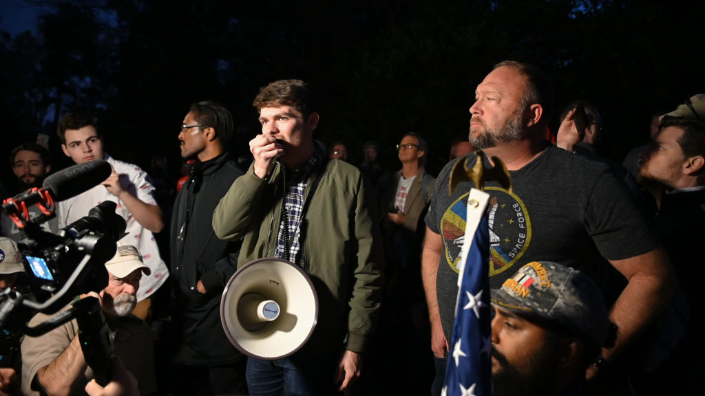Extreme far-right activists and their nickname "groyper" are trending online thanks to an alleged connection with Charlie Kirk's shooting. Here, Fuentes (C) hold a rally with fellow extreme conservative Alex Jones (R) in 2020. (Zach Roberts / NurPhoto / Getty Images)