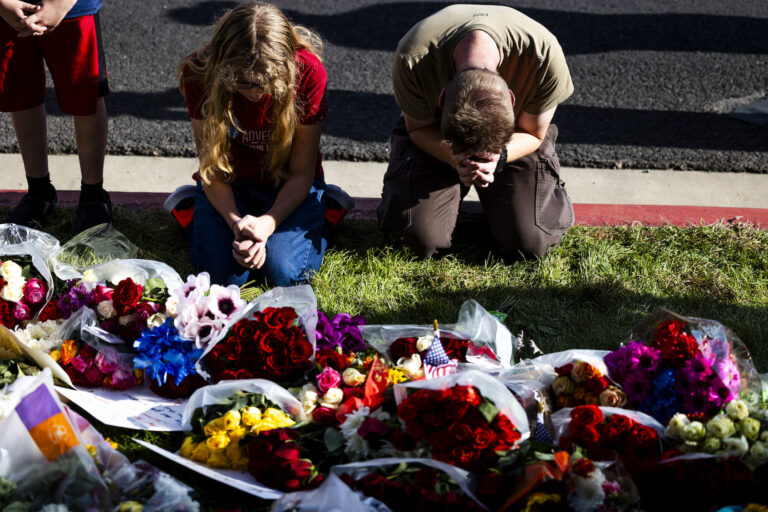 Christopher Bradford (right) and his daughter pray at a memorial for Charlie Kirk at Utah Valley University, Sept. 12, 2025. (Michael Ciaglo/Getty Images)
