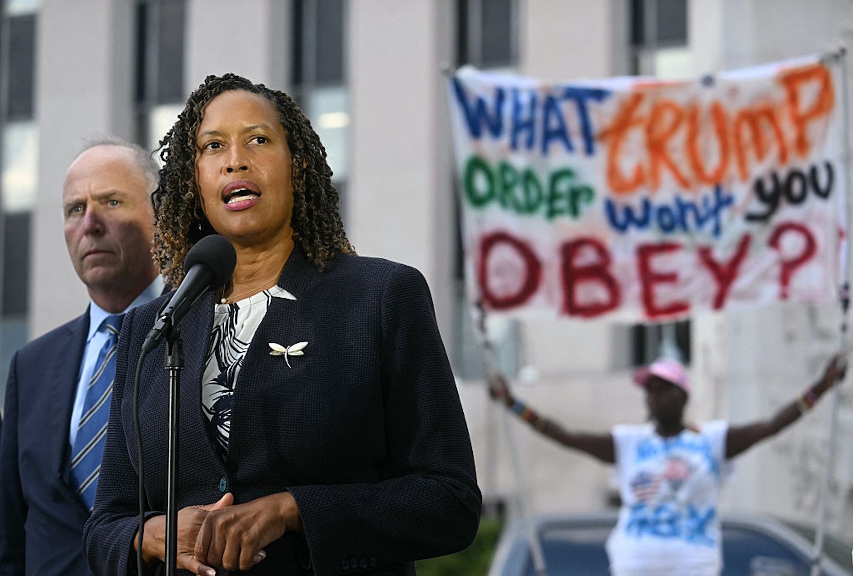 Washington, D.C. Mayor Muriel Bowser, flanked by D.C. Attorney General Brian Schwalb, speaks at a press conference on Aug. 15, 2025. (JIM WATSON/AFP via Getty Images)