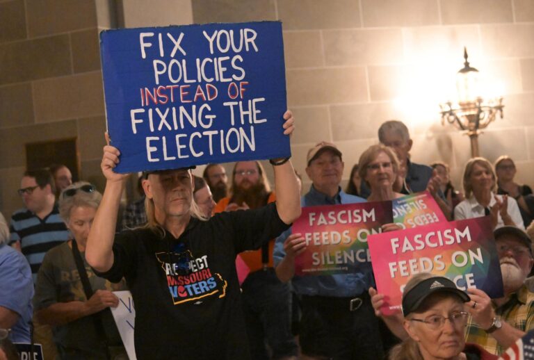 Protestors hold signs during a press conference inside the rotunda of the Missouri State Capitol Building on September 10, 2025 in Jefferson City, Missouri. Activists and concerned voters descended on the Missouri Capitol to protest the current plan on redistricting maps ahead of the midterm elections. (Photo by (Michael Thomas/Getty Images)