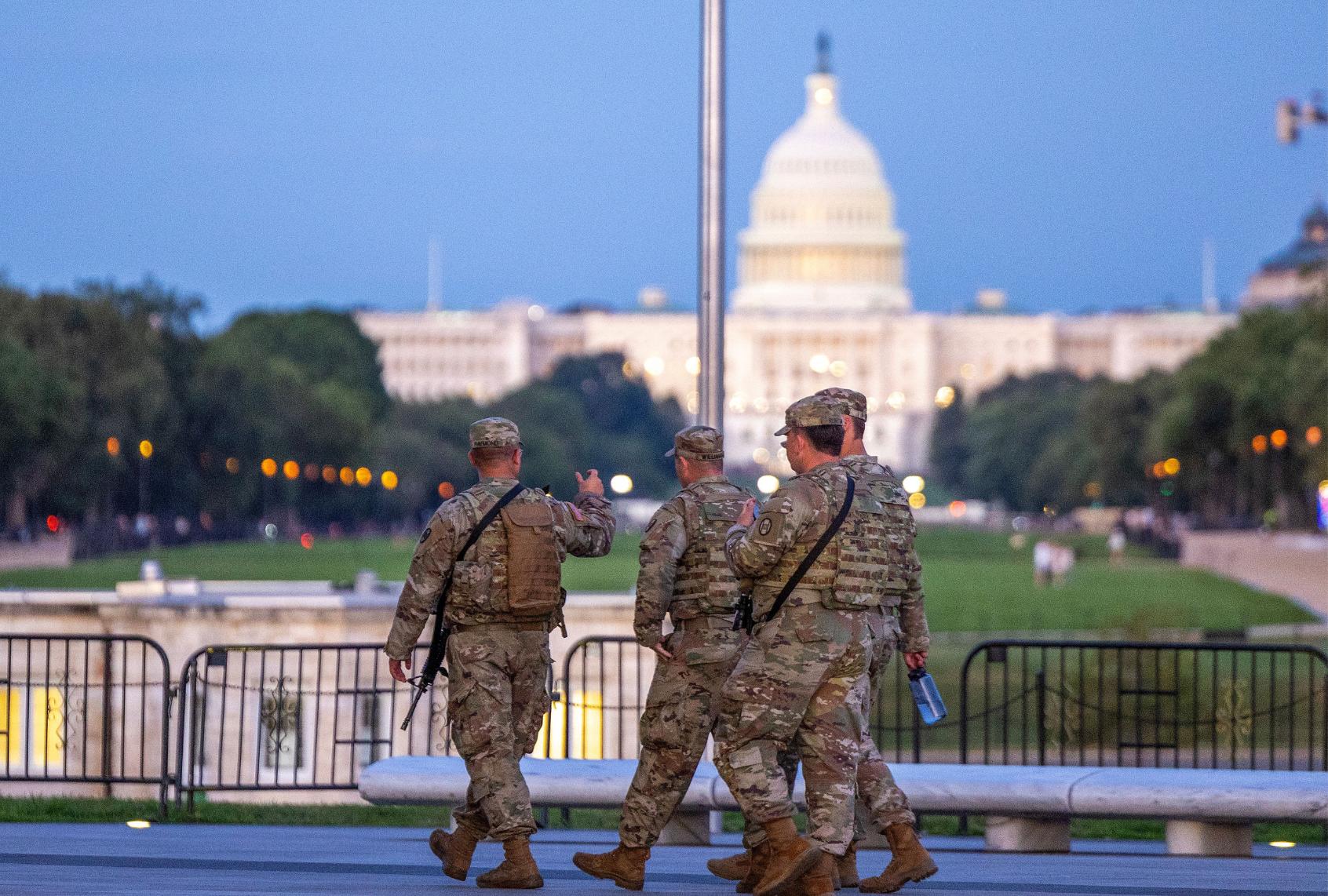 National Guard members patrol carrying weapons with the U.S. Capitol Building in the distance on August 25, 2025 in Washington, DC. (Tasos Katopodis/Getty Images)