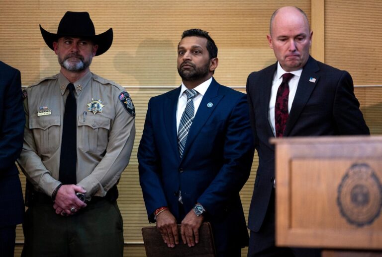 FBI director Kash Patel (C) stands with Utah Gov. Spencer Cox (R) before speaking at a press conference following the fatal shooting of political activist Charlie Kirk during an event at Utah Valley University on September 12, 2025 in Orem, Utah. Authorities announced that the suspect who shot and killed Kirk while he was speaking at an event for his "American Comeback Tour" has been apprehended and is in police custody. (Photo by (Michael Ciaglo/Getty Images)