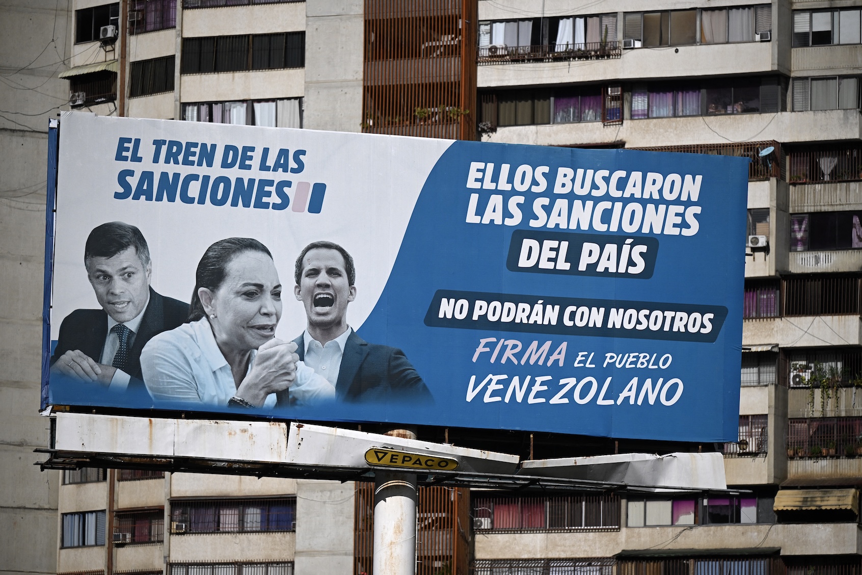 A billboard in Caracas accusing Nobel Peace Prize winner María Corina Machado (center) and other opposition leaders of supporting U.S. sanctions against Venezuela. (Federico Parra/AFP via Getty Images)