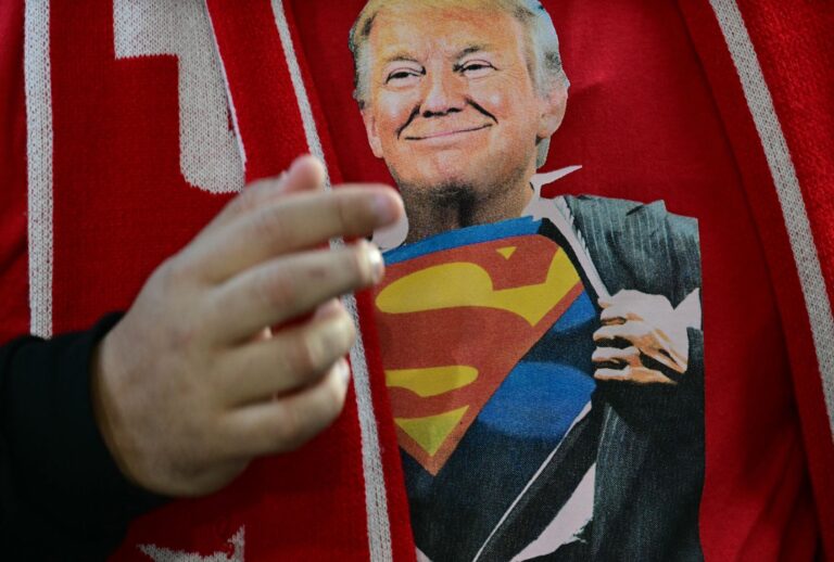 How Trump blurs reality for his base An attendee wears a Superman-Trump t-shirt at a campaign rally in Traverse City, Michigan on October 25, 2024. (JIM WATSON/AFP via Getty Images)