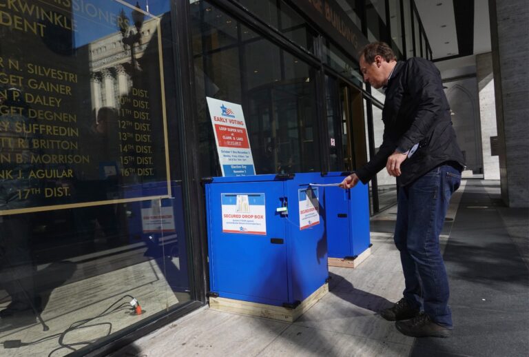 A resident drops off a vote-by-mail ballot in a secure drop box on October 2, 2020 in Chicago, Illinois. (Scott Olson/Getty Images)
