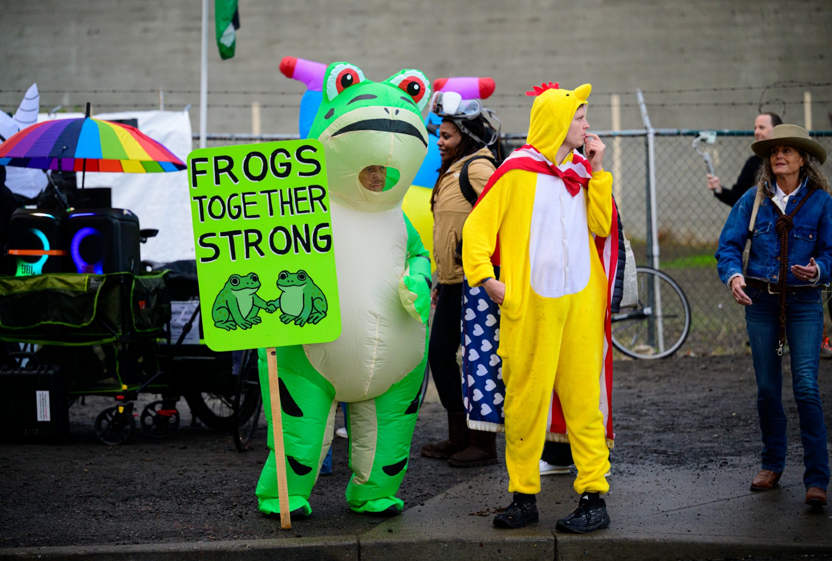 An anti-I.C.E. protester in a frog costume holds a sign at the U.S. Immigration and Customs Enforcement building on October 12, 2025 in Portland, Oregon. (Mathieu Lewis-Rolland/Getty Images)
