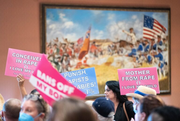 Protesters hold signs inside the South Carolina Statehouse as lawmakers debate an abortion ban on Aug. 30, 2022. (Sean Rayford/SOPA Images/LightRocket via Getty Images)