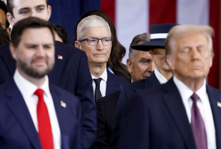 Apple CEO Tim Cook seen behind US President Donald Trump and US Vice President JD Vance at an inauguration ceremony in the rotunda of the United States Capitol on January 20, 2025 in Washington, DC. (Shawn Thew-Pool/Getty Images)