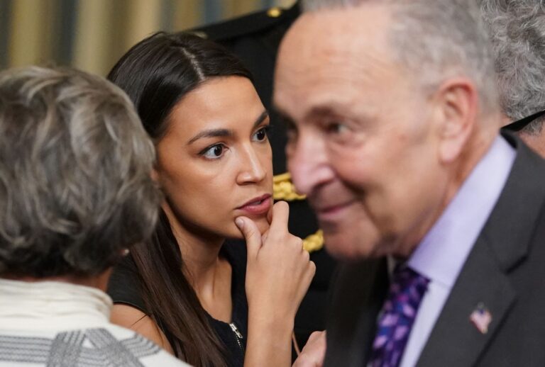 Rep. Alexandria Ocasio-Cortez D-NY, and Senate Majority Leader Chuck Schumer (R), D-NY during a ceremony in the White House in Washington, DC, on April 6, 2022. (MANDEL NGAN/AFP via Getty Images)