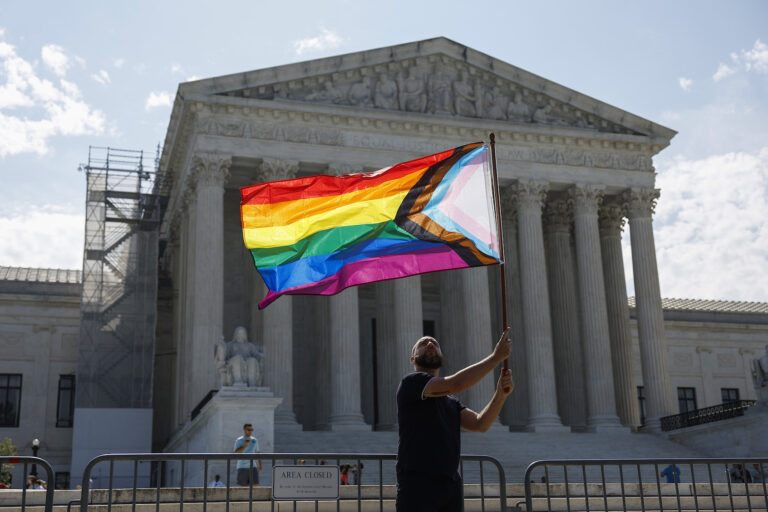 Same-sex marriage supporter Vin Testa, of Washington, DC, waves a LGBTQIA pride flag in front of the U.S. Supreme Court Building as he makes pictures with his friend Donte Gonzalez to celebrate the anniversary of the United States v. Windsor and the Obergefell v. Hodges decisions on June 26, 2023. (Photo by Anna Moneymaker/Getty Images)