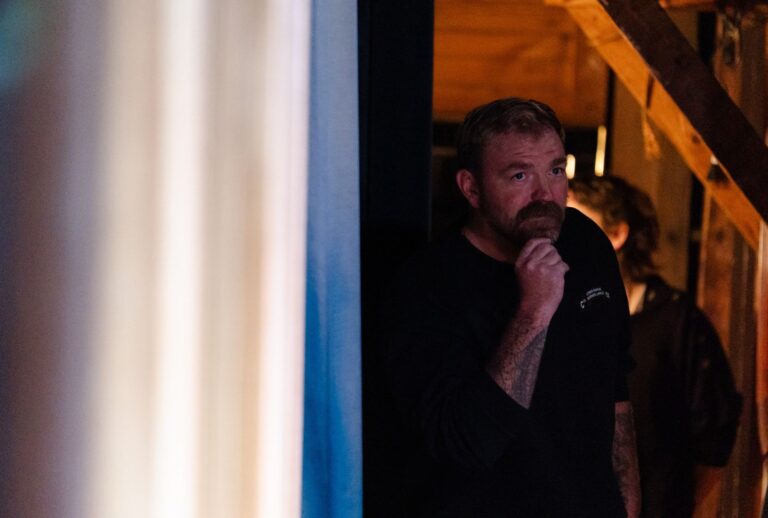 U.S. Senate candidate Graham Platner looks from backstage before a town hall on October 22, 2025 in Ogunquit, Maine. (Photo by Sophie Park/Getty Images)