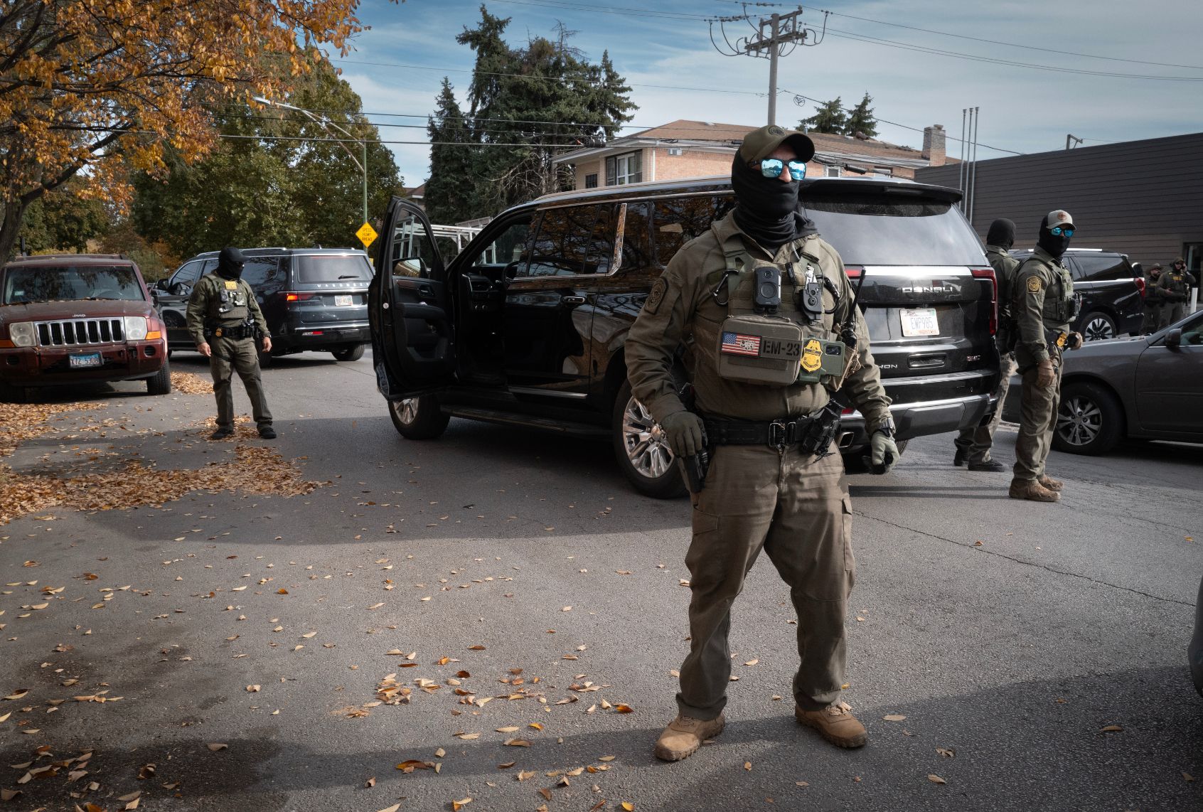 Federal agents stand guard as they are confronted by residents on November 06, 2025 in Chicago, Illinois. (Scott Olson/Getty Images)