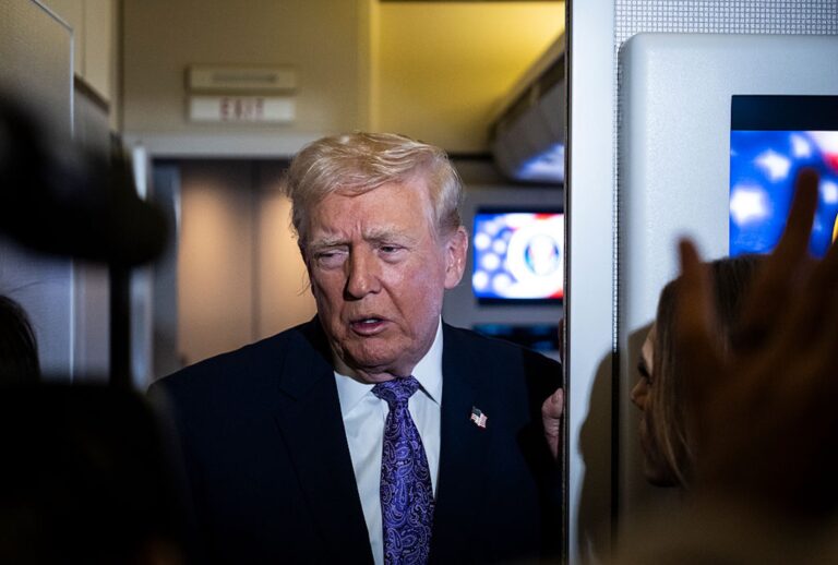 President Donald Trump speaks to the press aboard Air Force One on Nov. 30, 2025. (Pete Marovich/Getty Images)