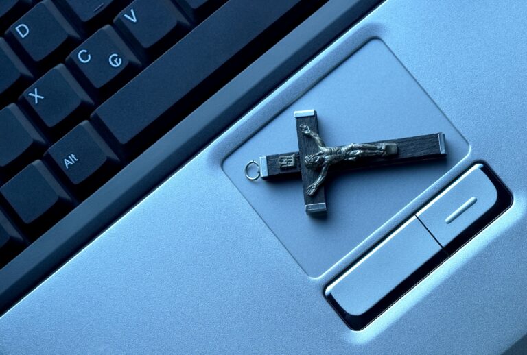 Crucifix on a laptop / Luso / Getty Images