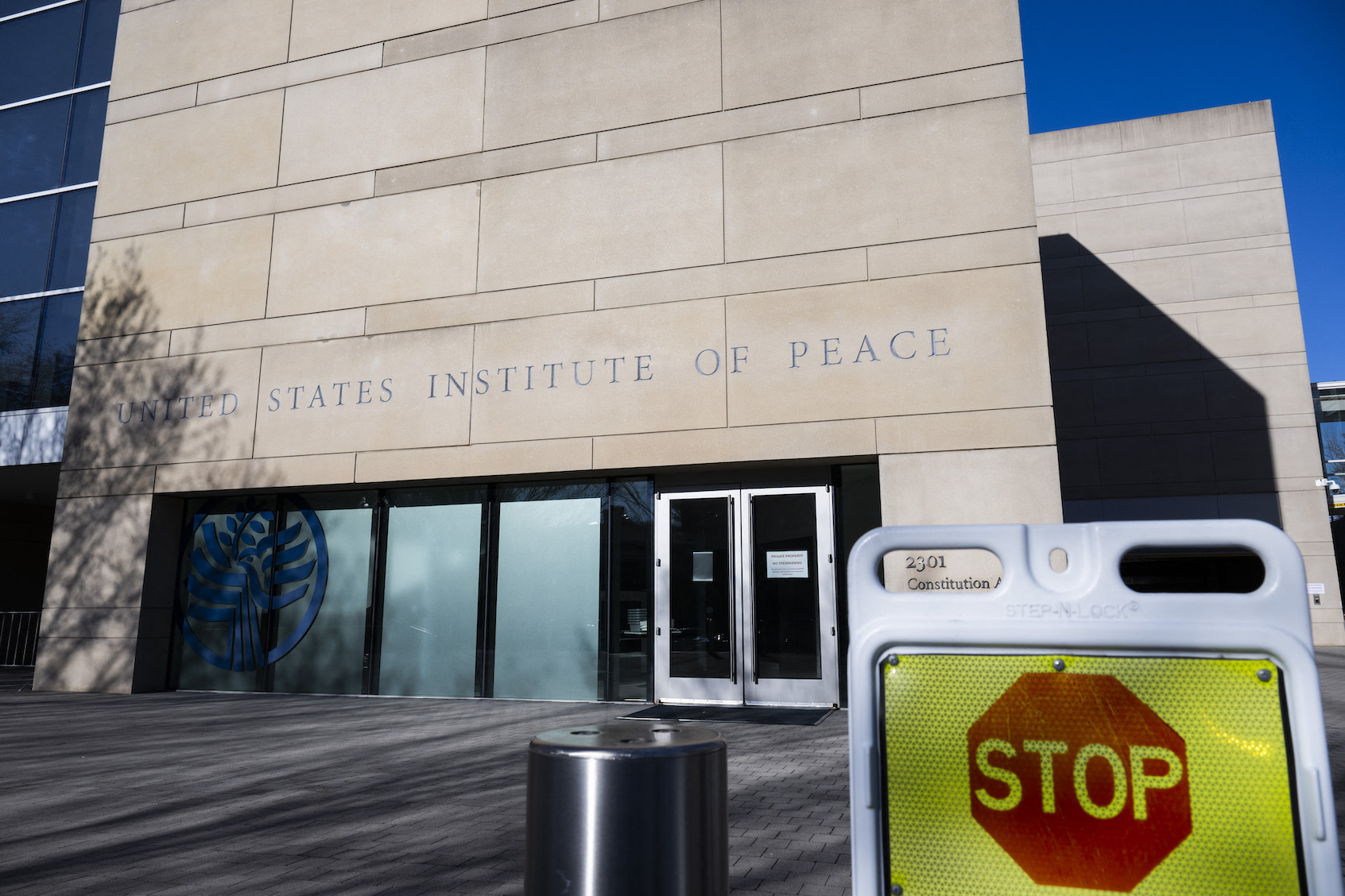 A stop sign outside the US Institute of Peace in Washington, DC, on March 18, 2025. Cost-slashers of US President Donald Trump seized control on March 17 of the institute, ousting the leader of the taxpayer-funded center for conflict resolution created by Congress in 1984. ((Photo by Roberto Schmidt/Getty Images))