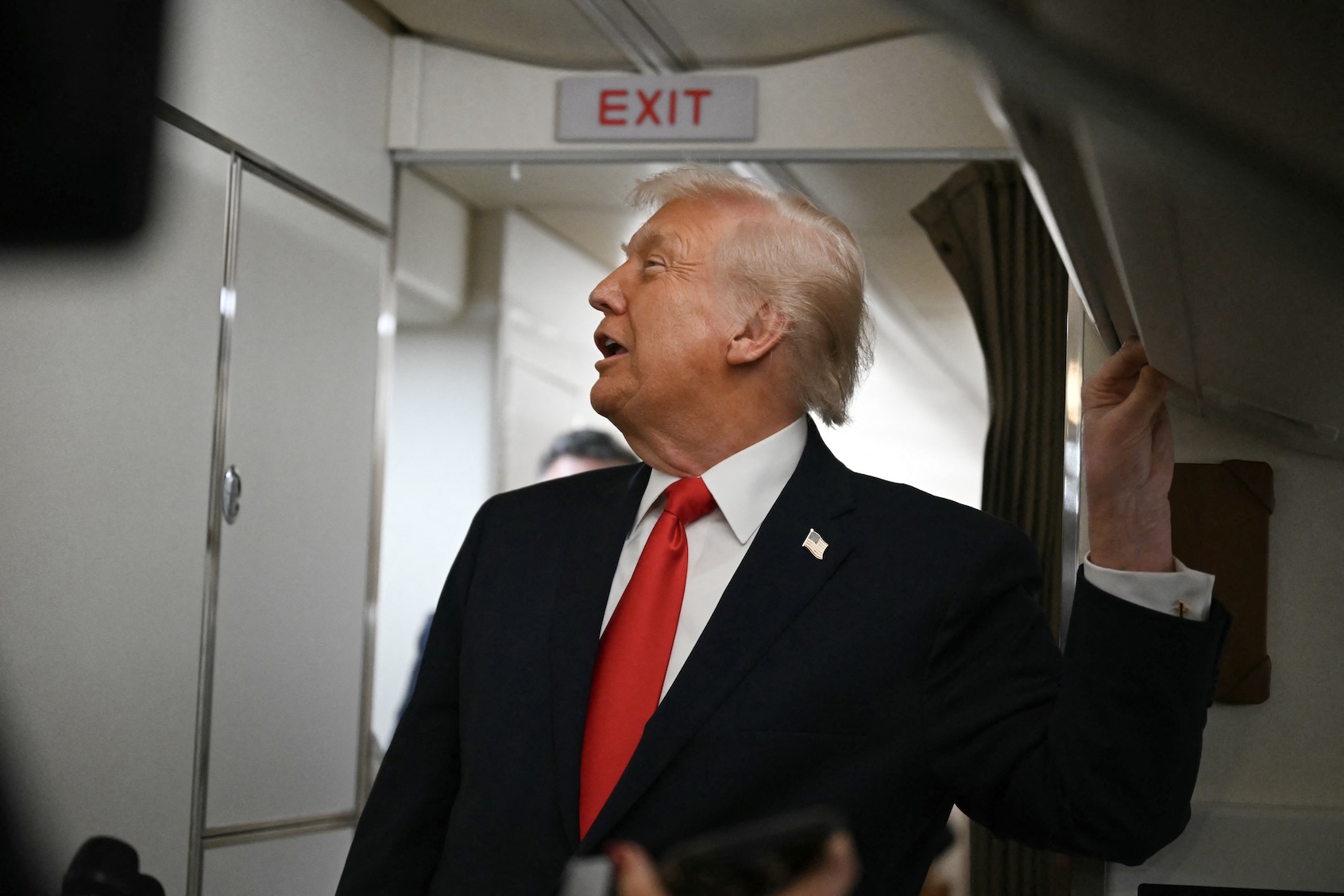 US President Donald Trump speaks to the media aboard Air Force One on December 9, 2025, en route to deliver remarks in Pennsylvania. ((Photo by Andrew Caballero-Reynolds/Getty Images)