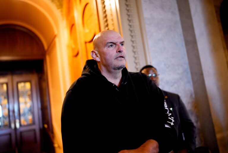 WASHINGTON, DC - DECEMBER 11: Sen. John Fetterman (D-PA) walks out of the Senate Chamber on December 11, 2025 in Washington, DC. Two opposing health care bills intended to avert rising health care premiums have failed. (Photo by Andrew Harnik/Getty Images)