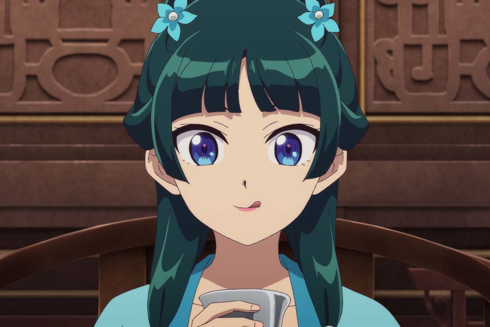 Animated still of a young girl with blue flowers in her green hair licks her lips after taking a sip from a cup