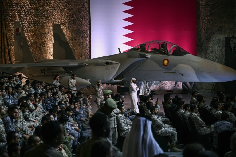 US and Qatari troops and staff await US President Donald Trump at the Al-Udeid air base southwest of Doha on May 15, 2025. (Photo by Brendan Smialowski/Getty Images)