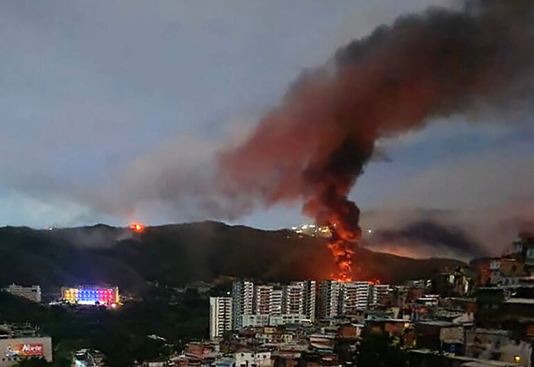 Overnight, U.S. forces struck multiple targets in Venezuela and captured its president and his wife to face charges in the U.S, leaving a fire at Fuerte Tiuna, Venezuela's largest military complex as the sun rose. (STR / Getty Images)