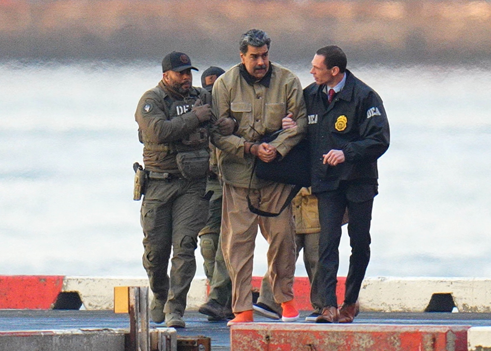 Nicolas Maduro is seen in handcuffs after landing at a Manhattan helipad, escorted by heavily armed Federal agents as they make their way into an armored car en route to a Federal courthouse in Manhattan on January 5, 2026 in New York City. (Photo by XNY/Star Max/Getty Images)
