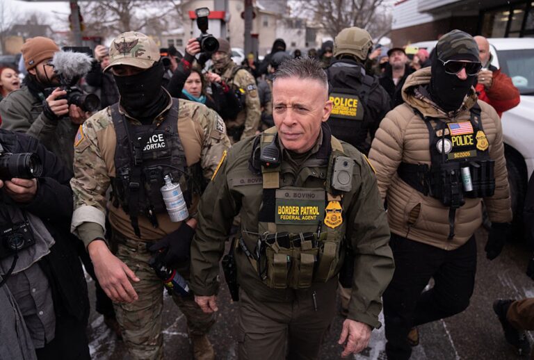 Border Patrol "commander at large" Gregory Bovino is flanked by his security team and protesters in Minnesota on Jan. 21, 2026. (Lokman Vural Elibol/Anadolu via Getty Images)
