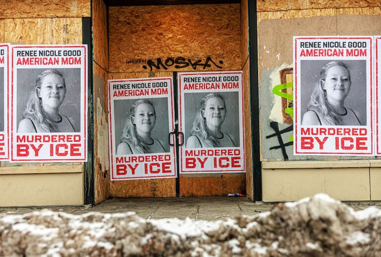Businesses boarded up in Minneapolis display posters of Renee Nicole Good following her fatal shooting by an ICE agent. (Kerem YUCEL / AFP via Getty Images)
