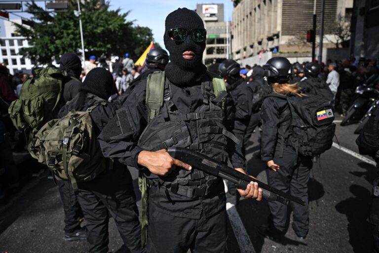 Armed supporters of Venezuela's President Nicolás Maduro gather near the Miraflores presidential palace in Caracas, Jan. 3, 2026. (Federico Parra / AFP via Getty Images)