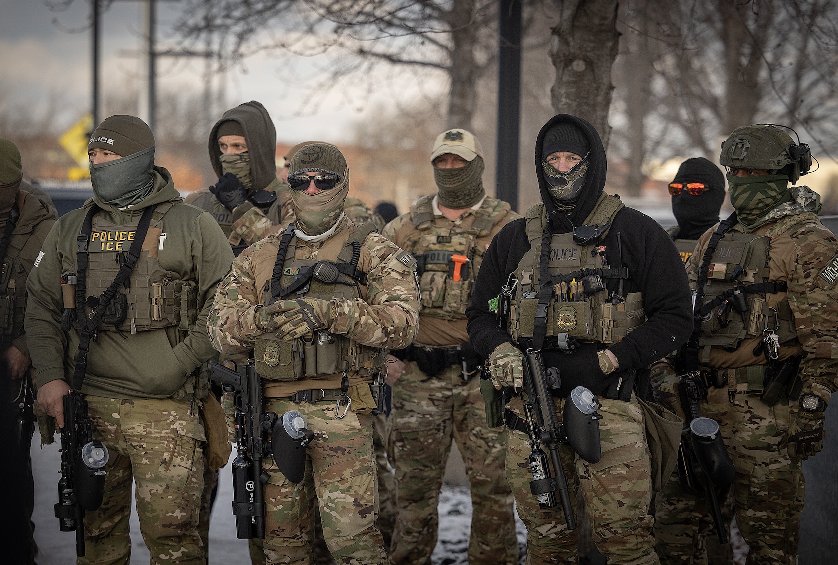 ICE Police watch as Rep. Ilhan Omar, center, U.S. Representative Kelly Morrison, left, and U.S. Representative Angie Craig, (not shown) on right, make their way into the the entrance of the Whipple Federal Building in Fort Snelling, MN on Saturday, Jan. 10, 2026. (Elizabeth Flores / Getty Images)