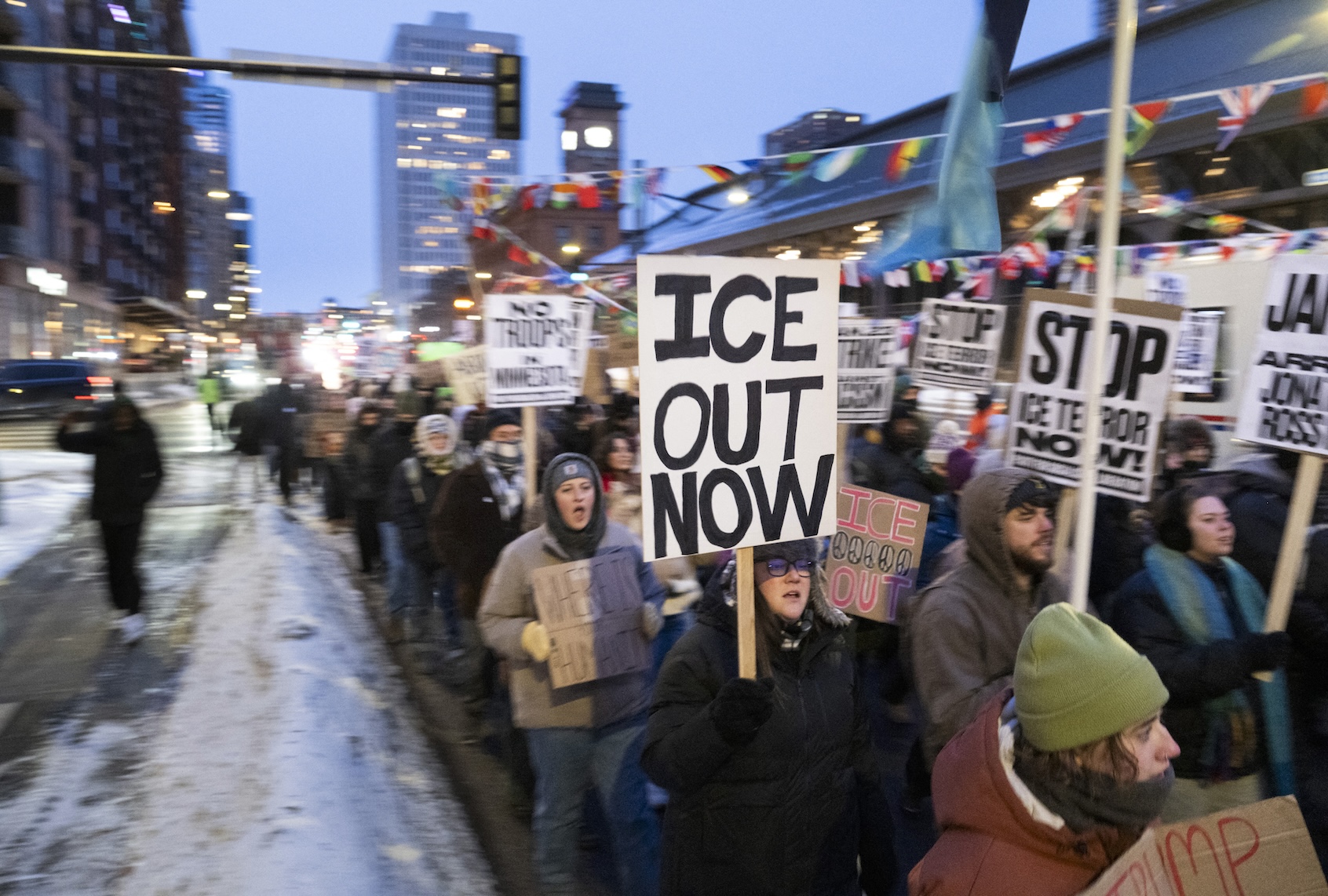 Demonstrators march during the nationwide "Stop ICE Terror" rally through downtown Minneapolis, Minnesota, on January 20, 2026 in protest against US President Donald Trump's policies. (Photo by ROBERTO SCHMIDT / AFP / Getty Images)