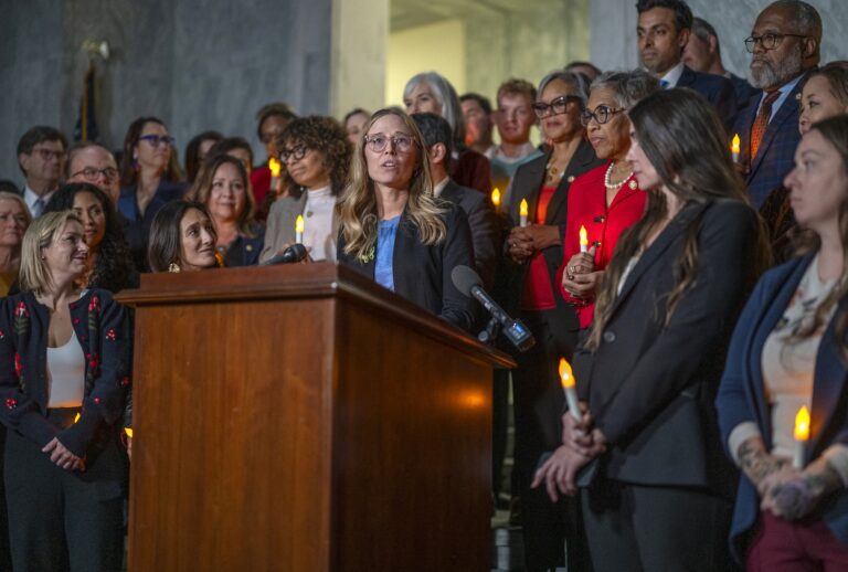 Annie Farmer, victim of convicted sex offender Jeffrey Epstein, speaks from the podium during a candlelight vigil to honor survivors of his crimes in Washington, DC on November 18, 2025. (Photo by DANIEL HEUER / AFP via Getty Images)