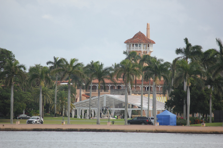 Law enforcement and maintenance crews are visible outside Mar-a-Lago in Palm Beach, Florida, on Jan. 17, 2026. Temporary tents and service vehicles remain on the lawn as personnel work near the waterfront estate. (Christopher Beckett / Getty Images)