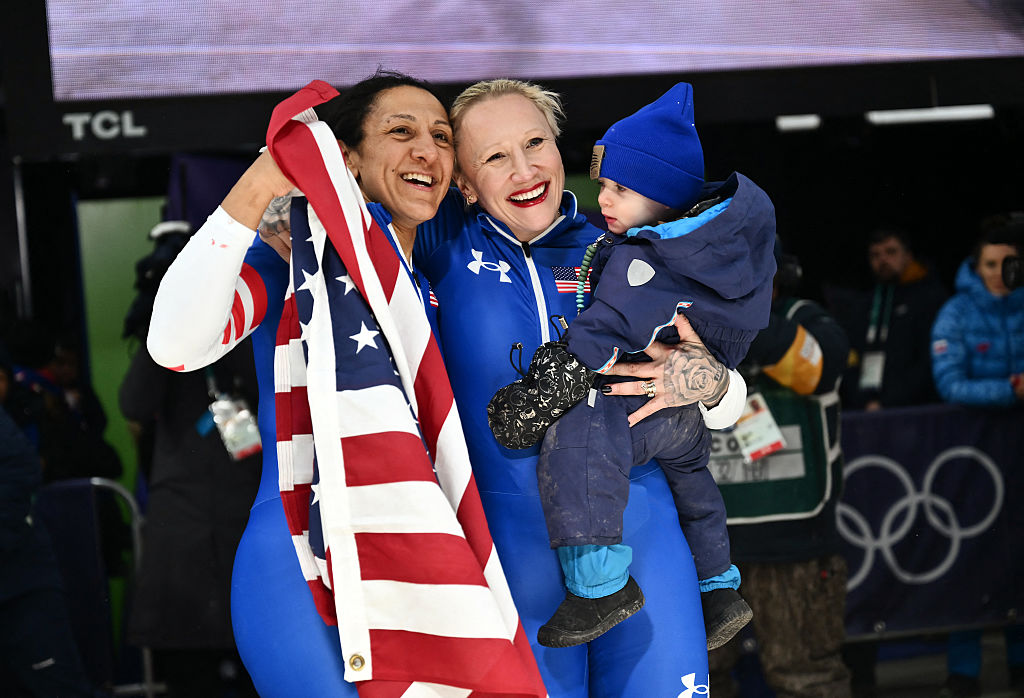 USA's Elana Meyers Taylor and USA's Kaillie Armbruster Humphries pose for pictures after winning gold and bronze respectively in the bobsleigh women's monobob heat 4 at the Milano Cortina 2026 Winter Olympic Games. aylor and Humphries have both spoken openly about balancing motherhood and Olympic competition. (Marco BERTORELLO / AFP via Getty Images)